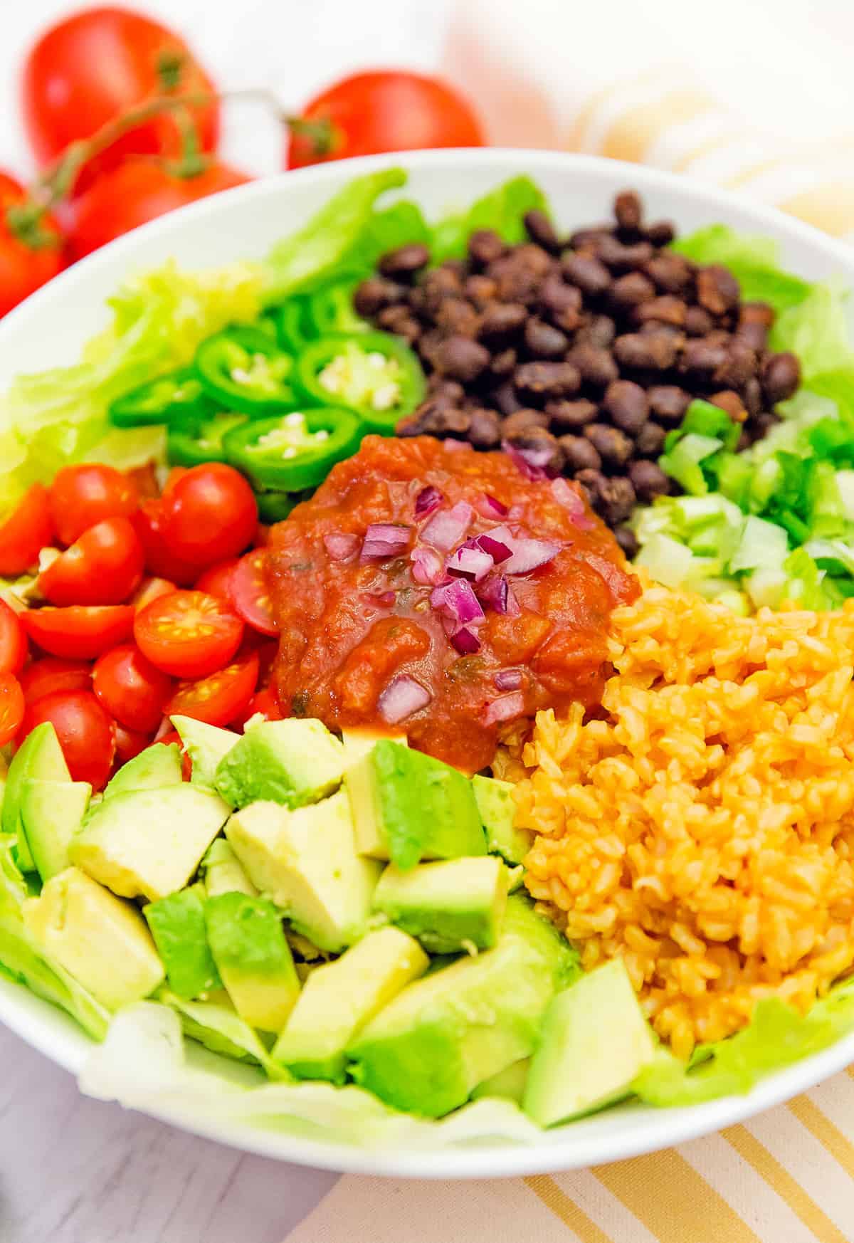 Salsa veggie bowl, veggie bowl, salsa bowl, whole food plant based bowl, recipe, veggie bowl recipe, whole food plant based salad, salsa bowl recipe, vegan, vegan recipe, whole food plant based recipe, whole food plant based, vegetarian, vegetarian recipe, gluten free, gluten free recipe, vegan dinner, vegan lunch, vegan meals, vegetarian dinner, vegetarian lunch, vegetarian meal, whole food plant based dinner, whole food plant based lunch, whole food plant based meal, gluten free dinner, gluten free lunch, gluten free meal, healthy, oil free, no oil, red onions, black beans, lettuce, salad, corn, Mexican rice, Spanish rice, rice, black beans, green onions, tomatoes, jalapeño, quick dinner, avocado, salsa dressing, fast dinner, entertaining, wfpb, dairy free, no dairy, traditional, Mexican, Southwestern, classic, delicious, the best, winter, fall, spring, summer, fast, easy, quick, simple, 30 minutes,