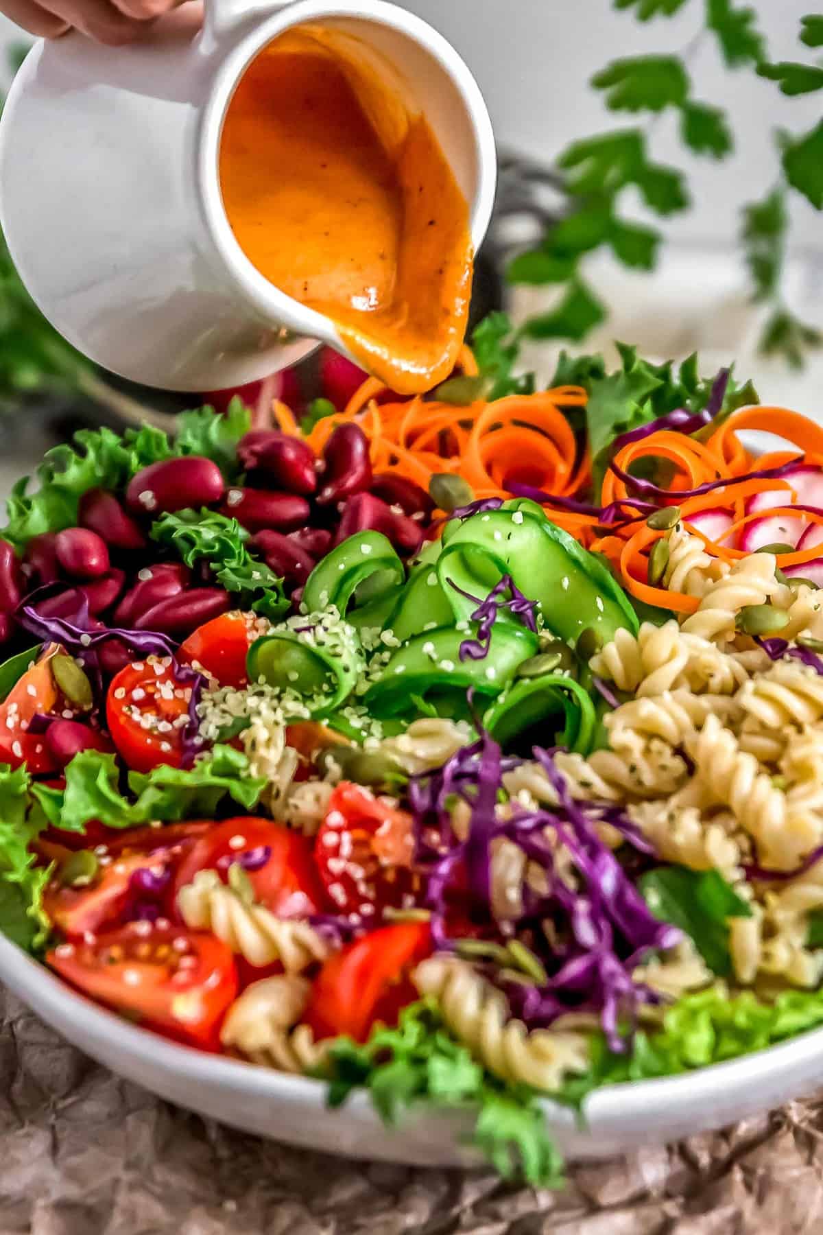 Pouring Oil Free Catalina Dressing on veggie bowl