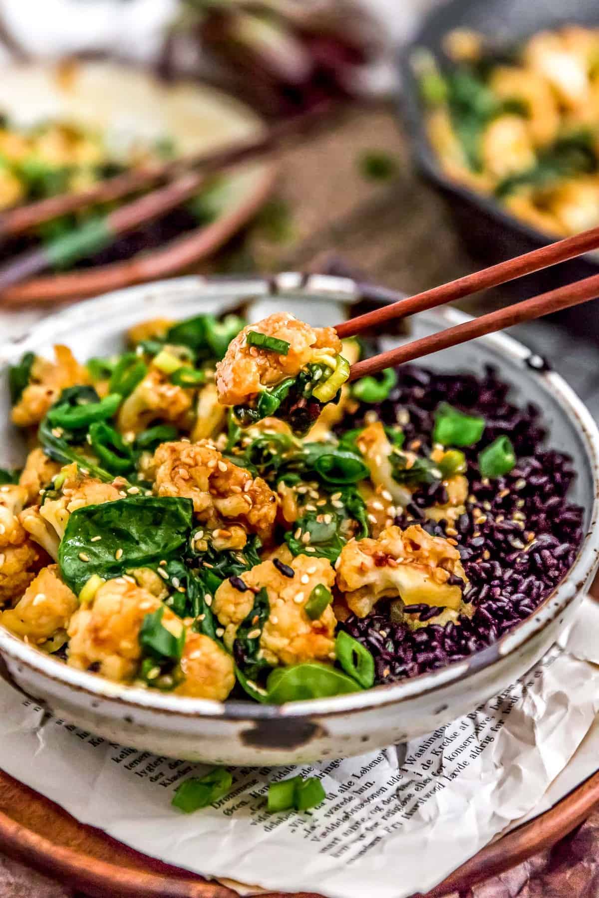 Chopsticks picking up a Vegan Korean BBQ Cauliflower