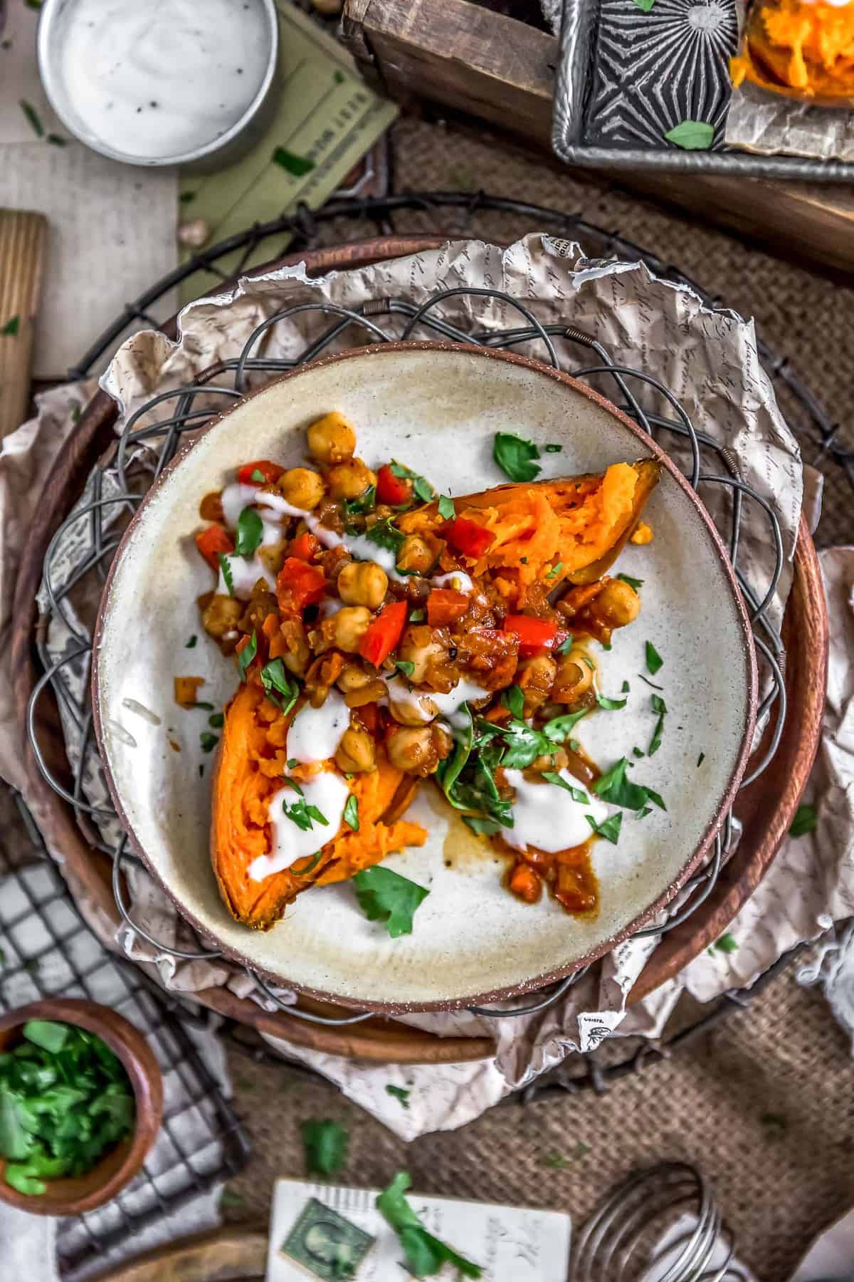Plated Moroccan Spiced Chickpeas and Garlic Sauce over a sweet potato