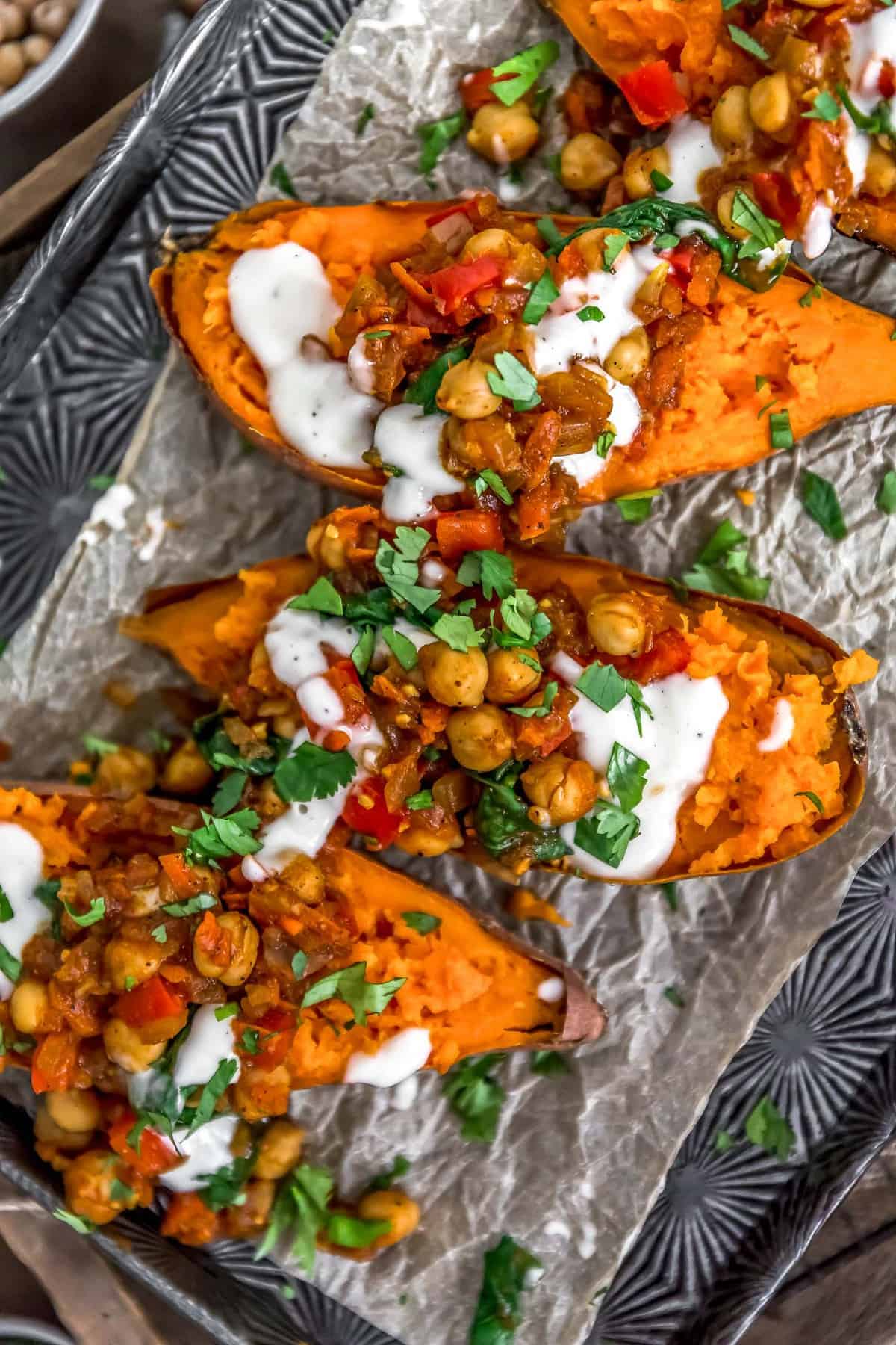 Close up of Moroccan Spiced Chickpeas and Garlic Sauce over sweet potatoes