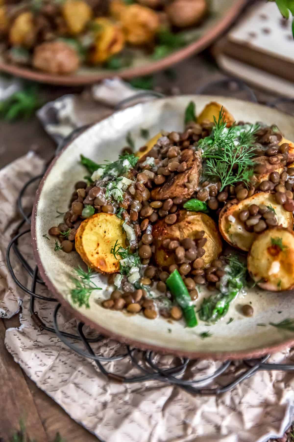 Sideview of Roasted Potatoes with Seasoned Lentils and Dill Sauce