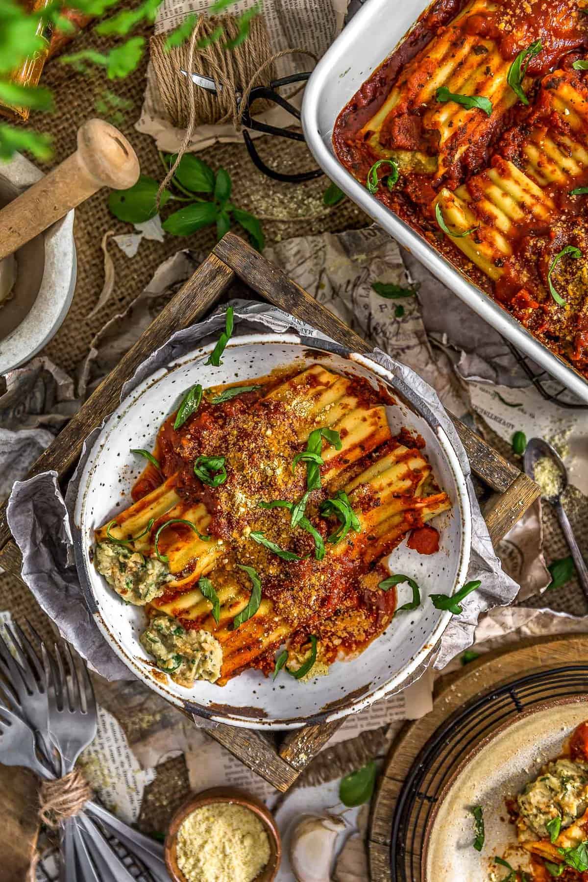 Tablescape of Vegan Manicotti Stuffed with Cauliflower Cream and Spinach