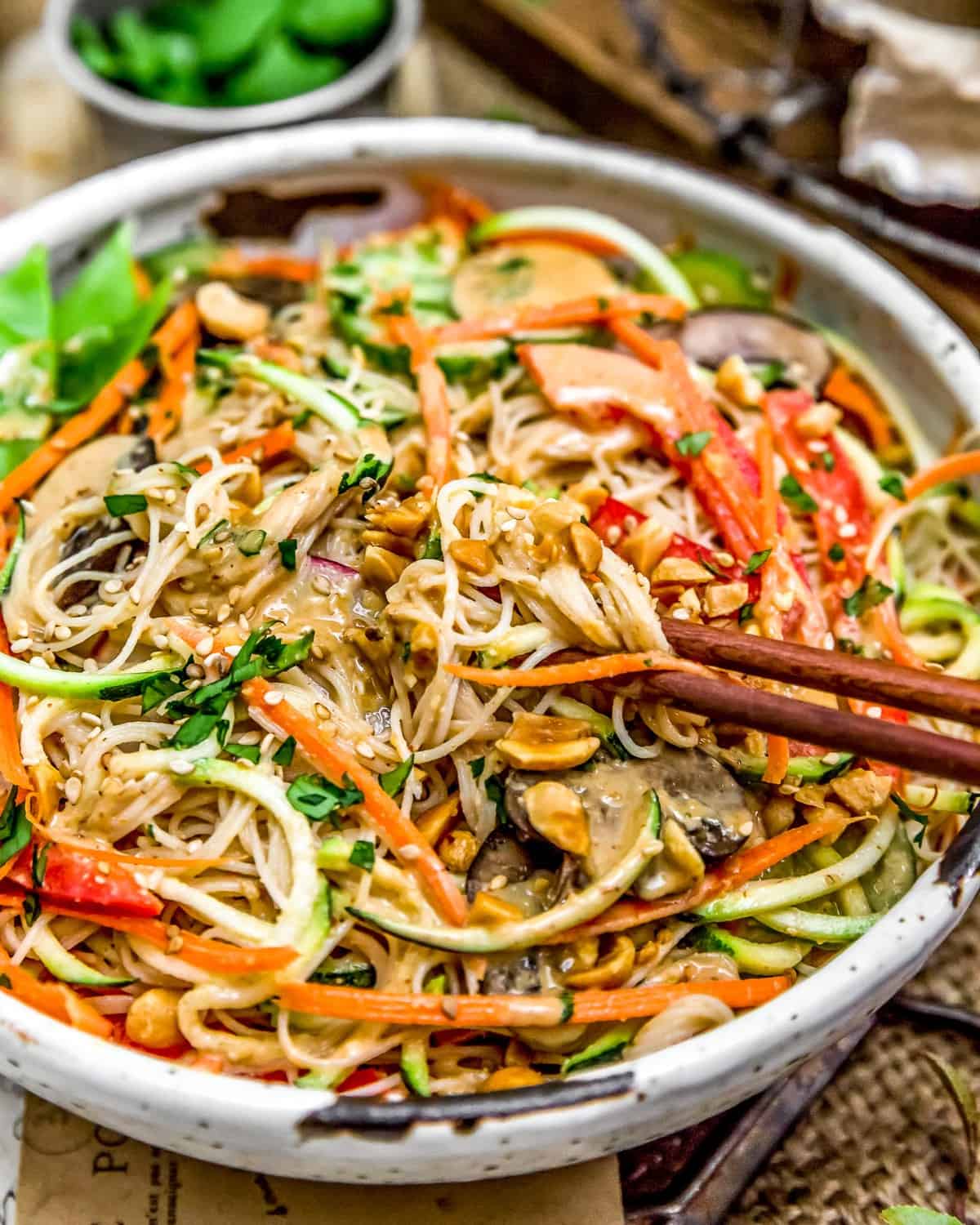 Eating veggie bowl with Spicy Peanut Dressing