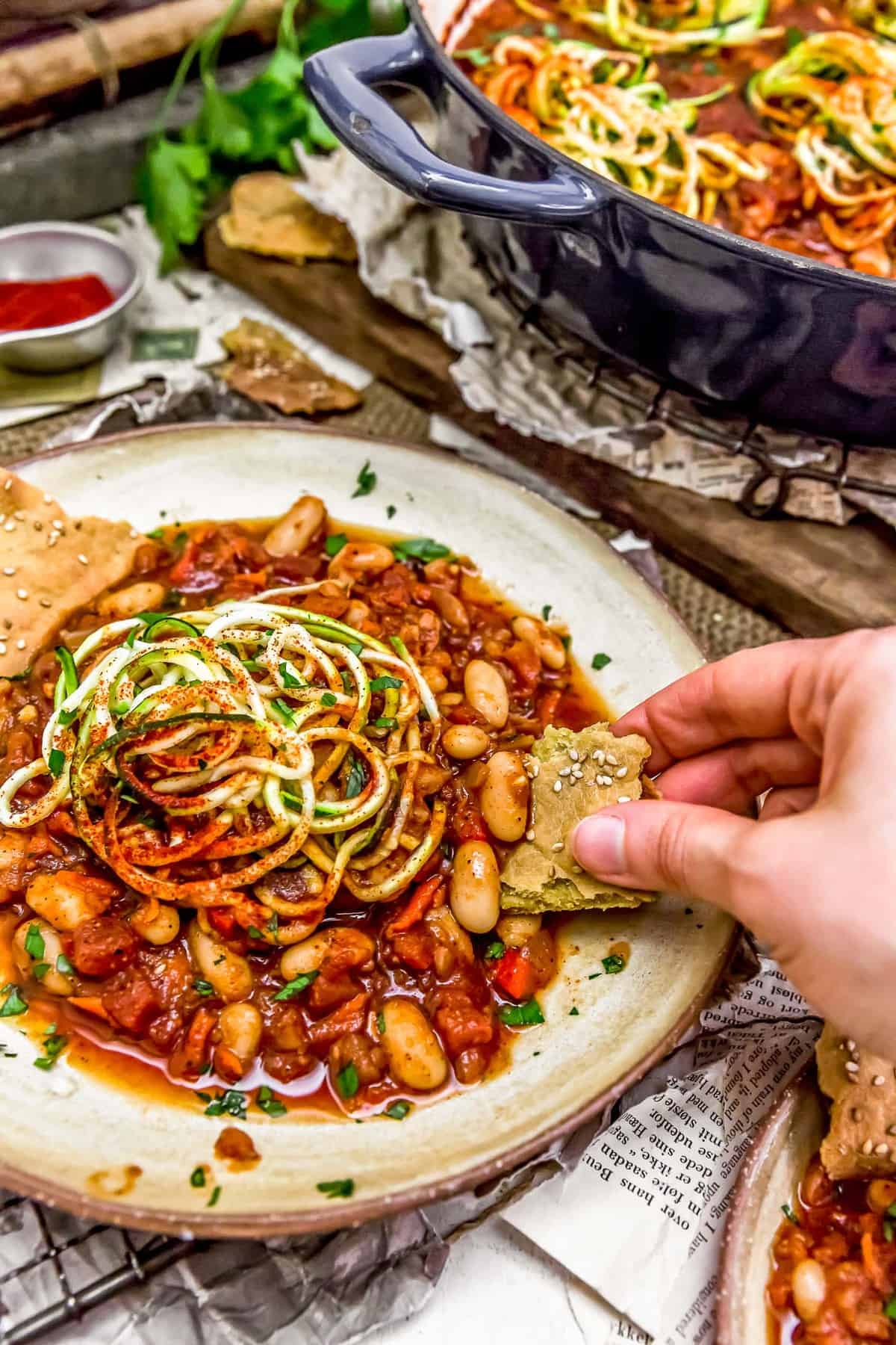 Dipping flatbread in Vegan Veggie Shakshuka