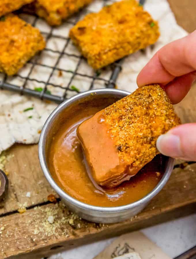 Dipping tofu nugget in Maple Mustard Dipping Sauce