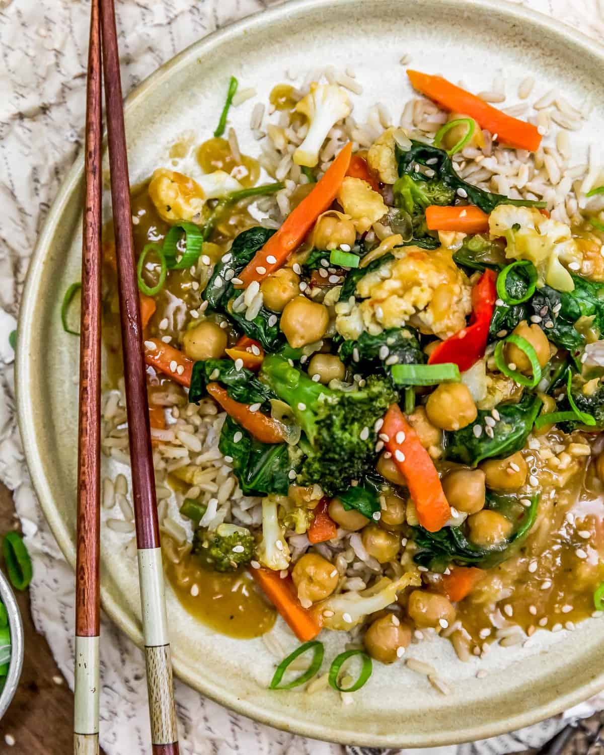 Plate of Orange Veggie Stir Fry with chopsticks