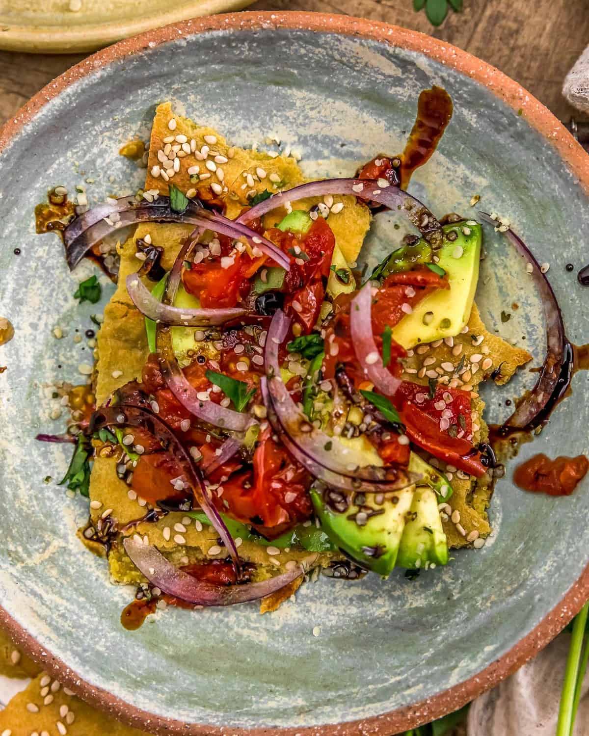 Roasted Tomato Stuffed Avocados on a quinoa flatbread