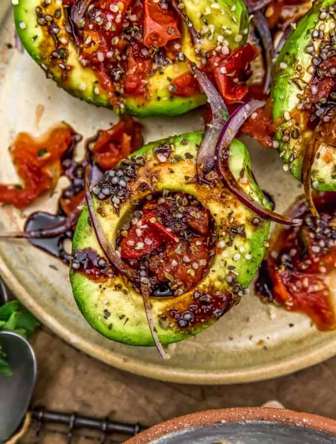 Close up of Roasted Tomato Stuffed Avocados with Balsamic Reduction