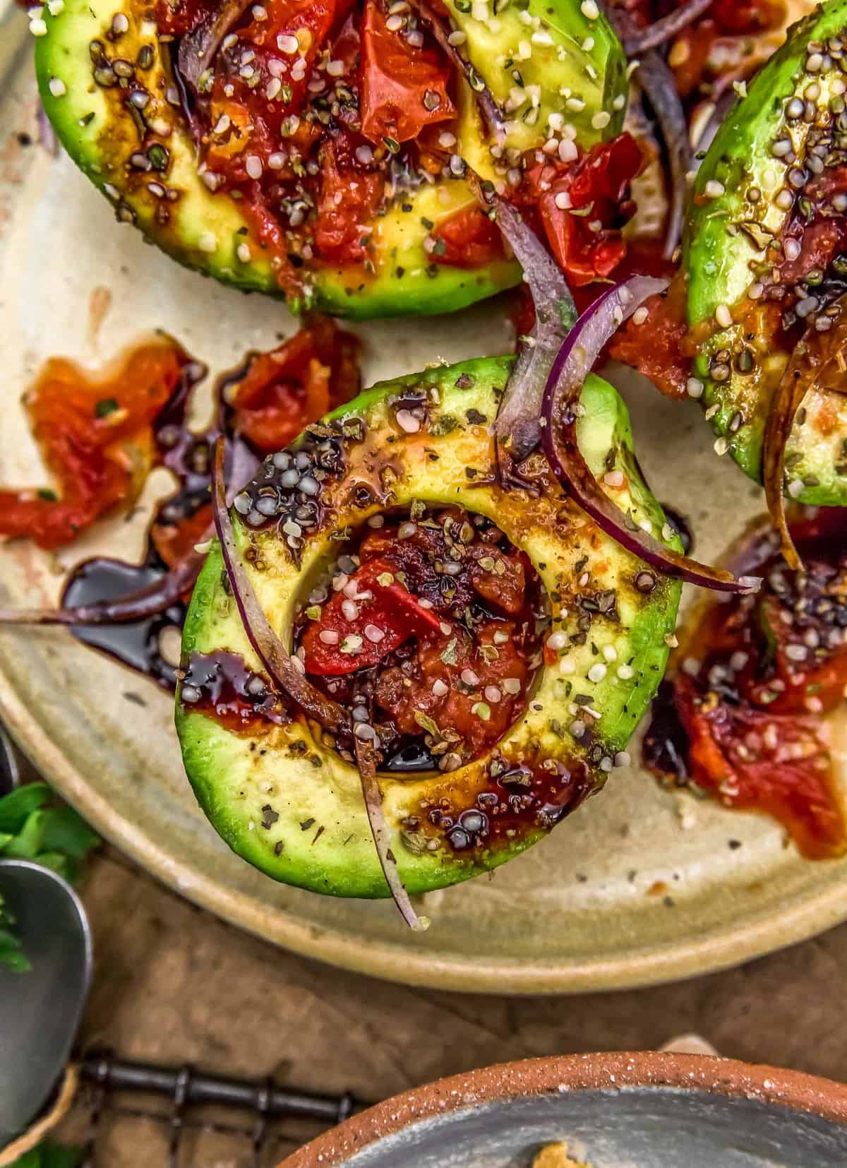 Close up of Roasted Tomato Stuffed Avocados with Balsamic Reduction