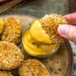 Dipping Vegan Chickpea Nuggets in sauce