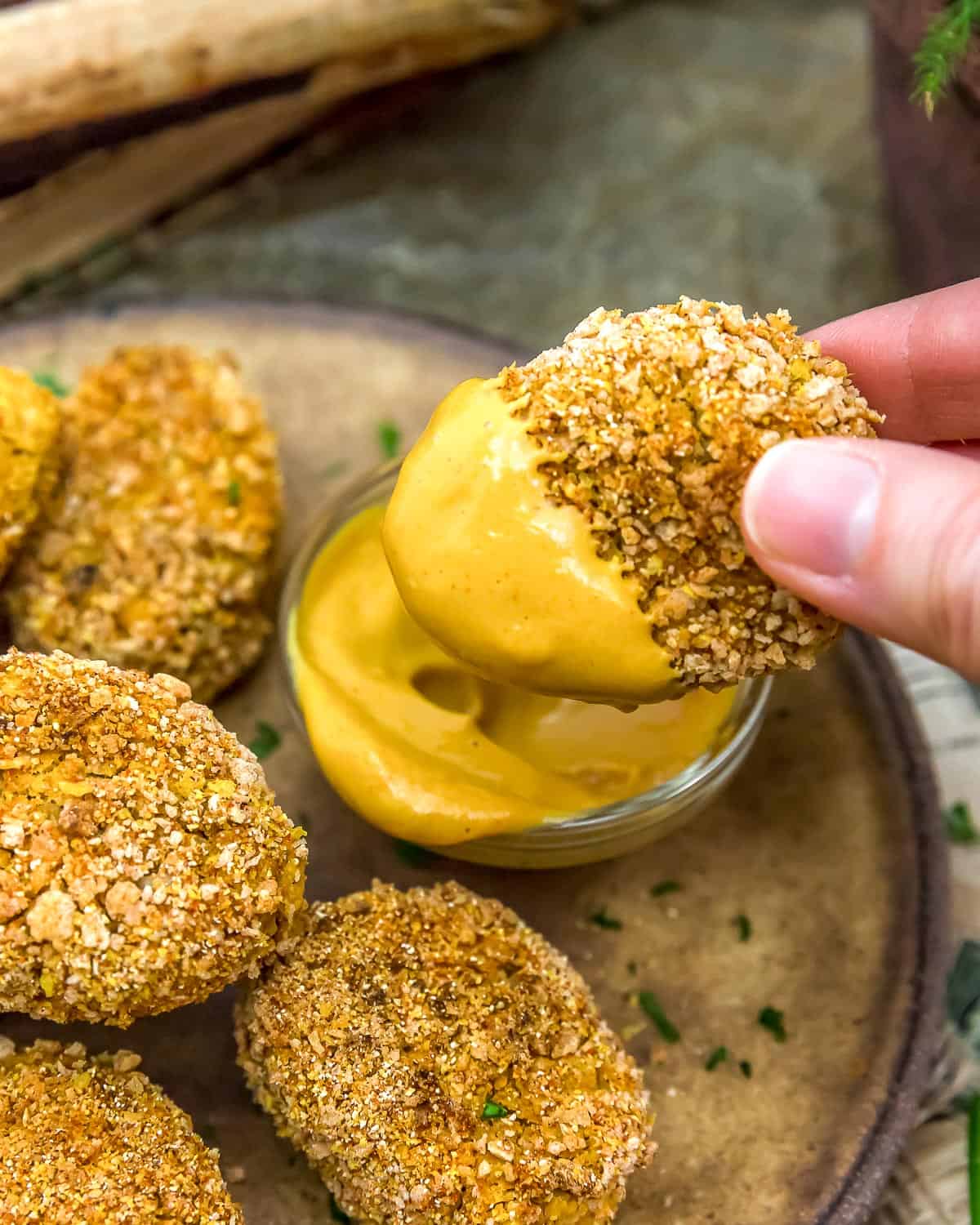 Dipping Vegan Chickpea Nuggets in sauce