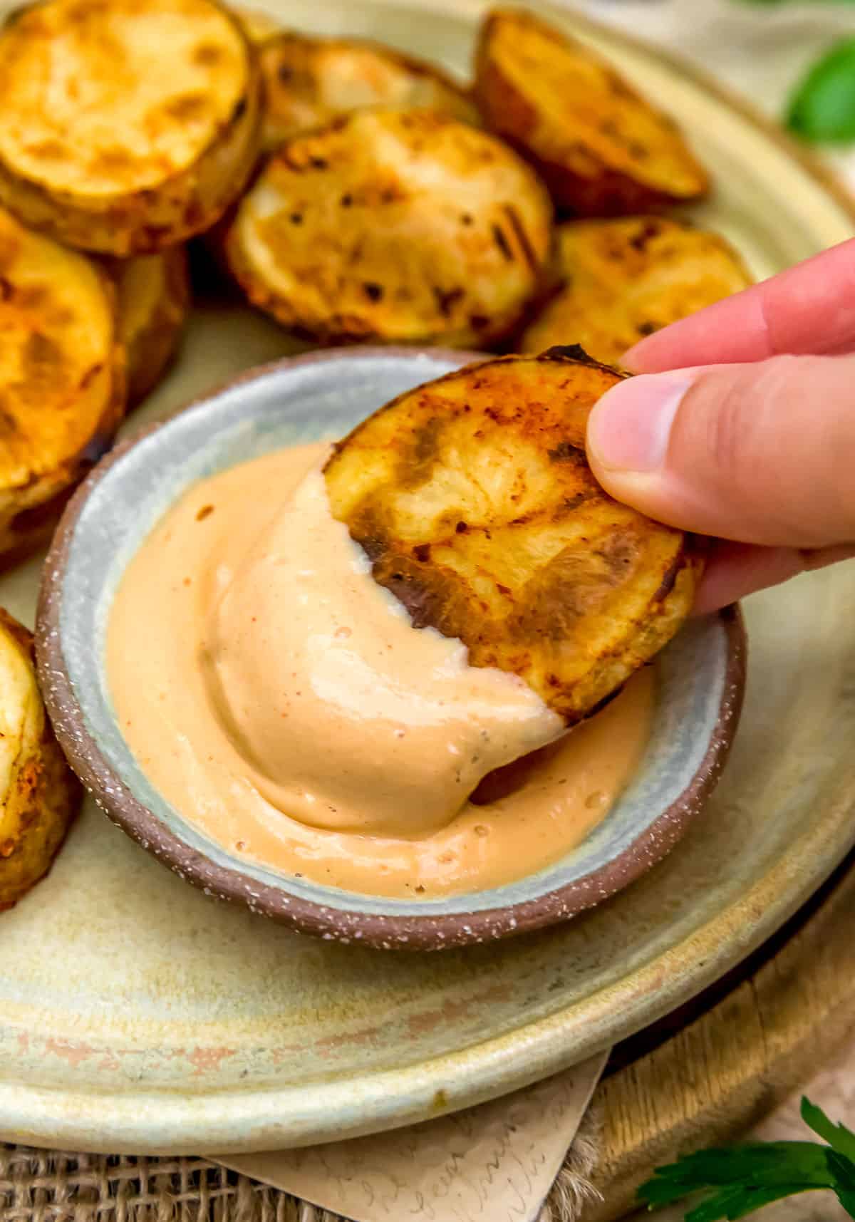 Fries dipping in Vegan Fry Sauce