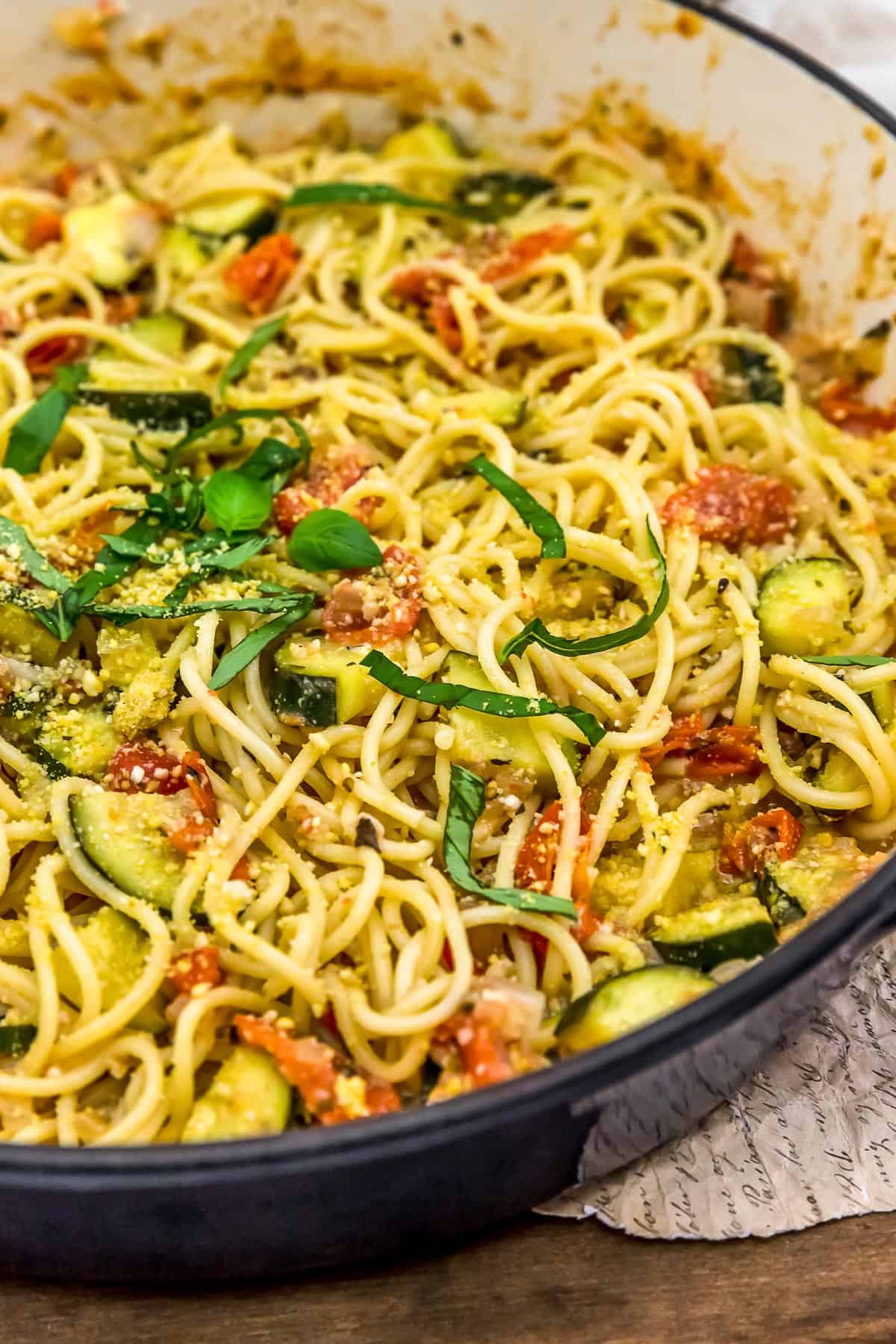 Close up skillet of Vegan Parmesan Zucchini and Tomato Pasta