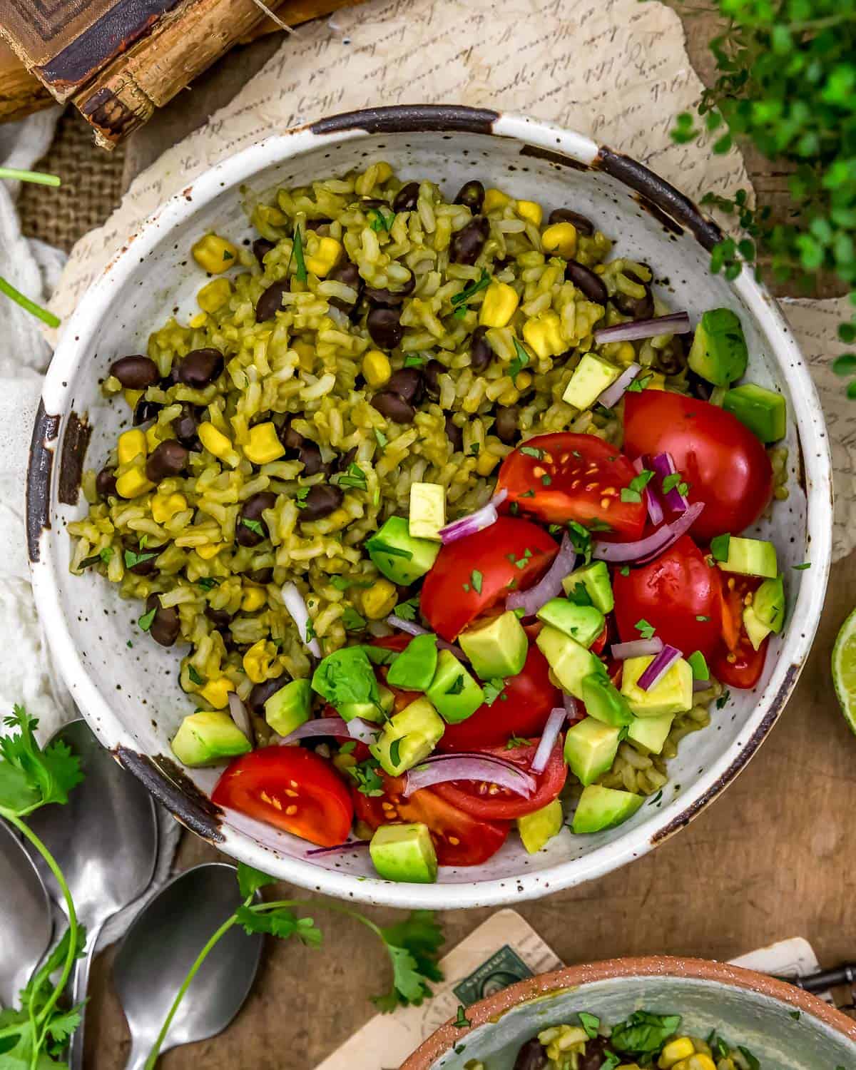 Bowl of Oil-Free Mexican Green Rice with tomatoes and avocados