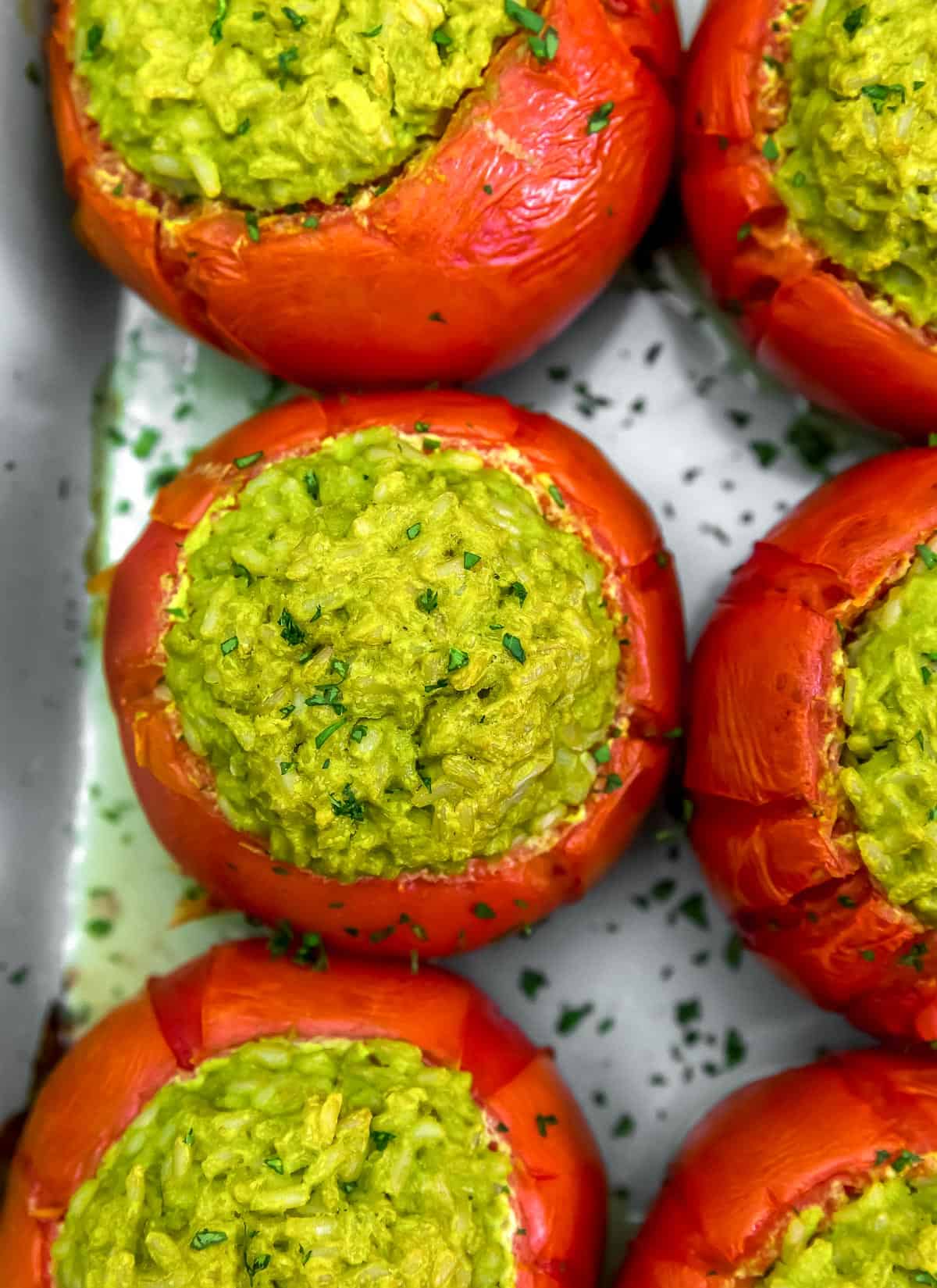 Close up of Oil Free Vegan Pesto Rice Stuffed Tomatoes
