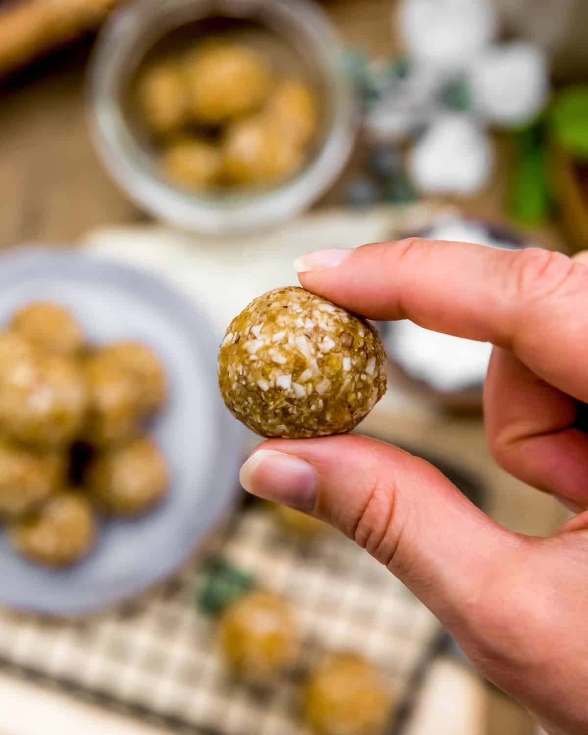 Holding a No Bake Apricot-Coconut Bliss Ball