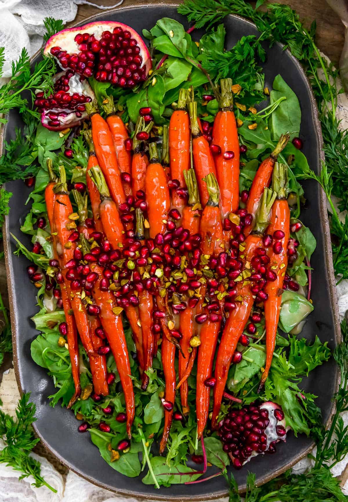 Roasted Maple Glazed Carrots in Tahini Sauce with Pomegranate and Pistachios on a serving platter