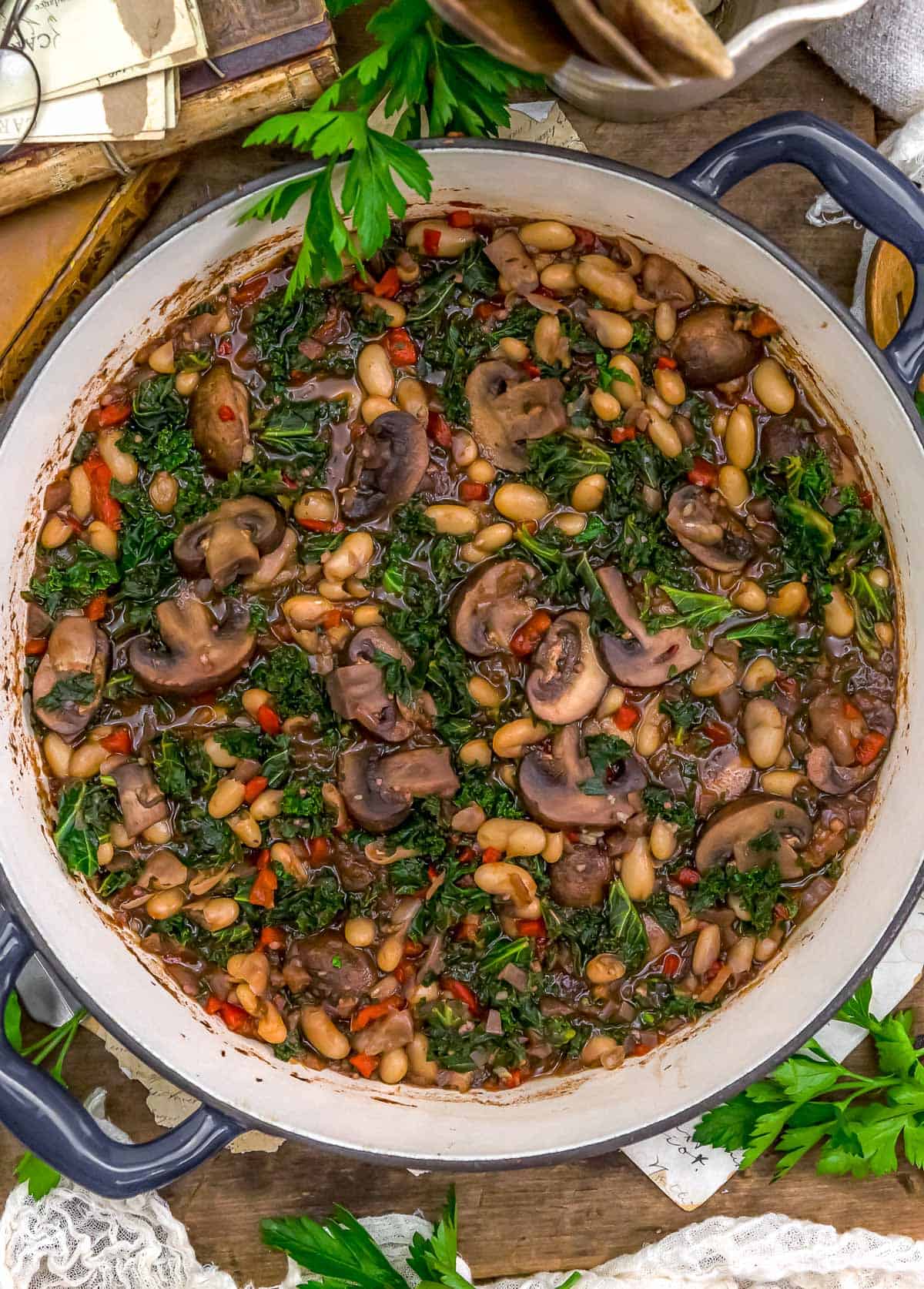 Mushrooms Beans and Kale in Red Wine Sauce in a skillet