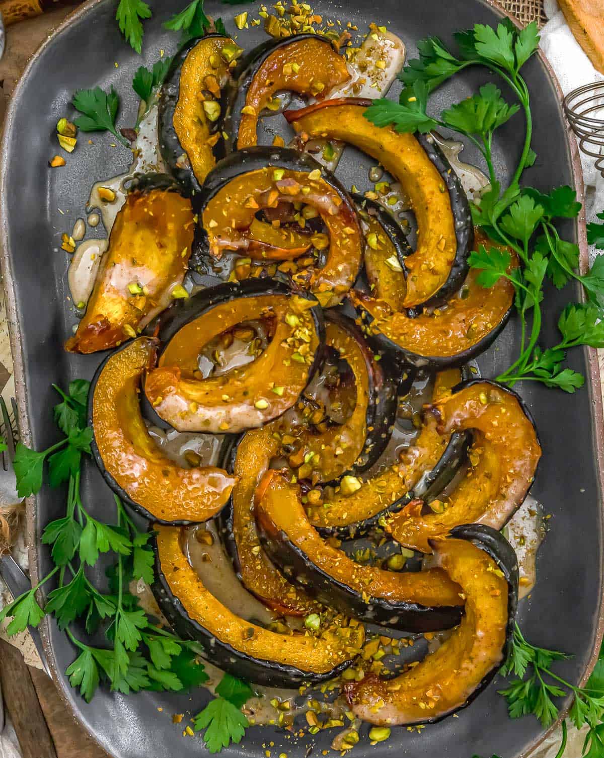 Serving tray of Roasted Acorn Squash with Maple Sauce and Pistachios