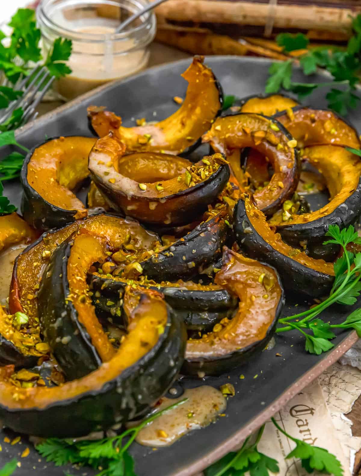 Plate of Roasted Acorn Squash with Maple Sauce and Pistachios