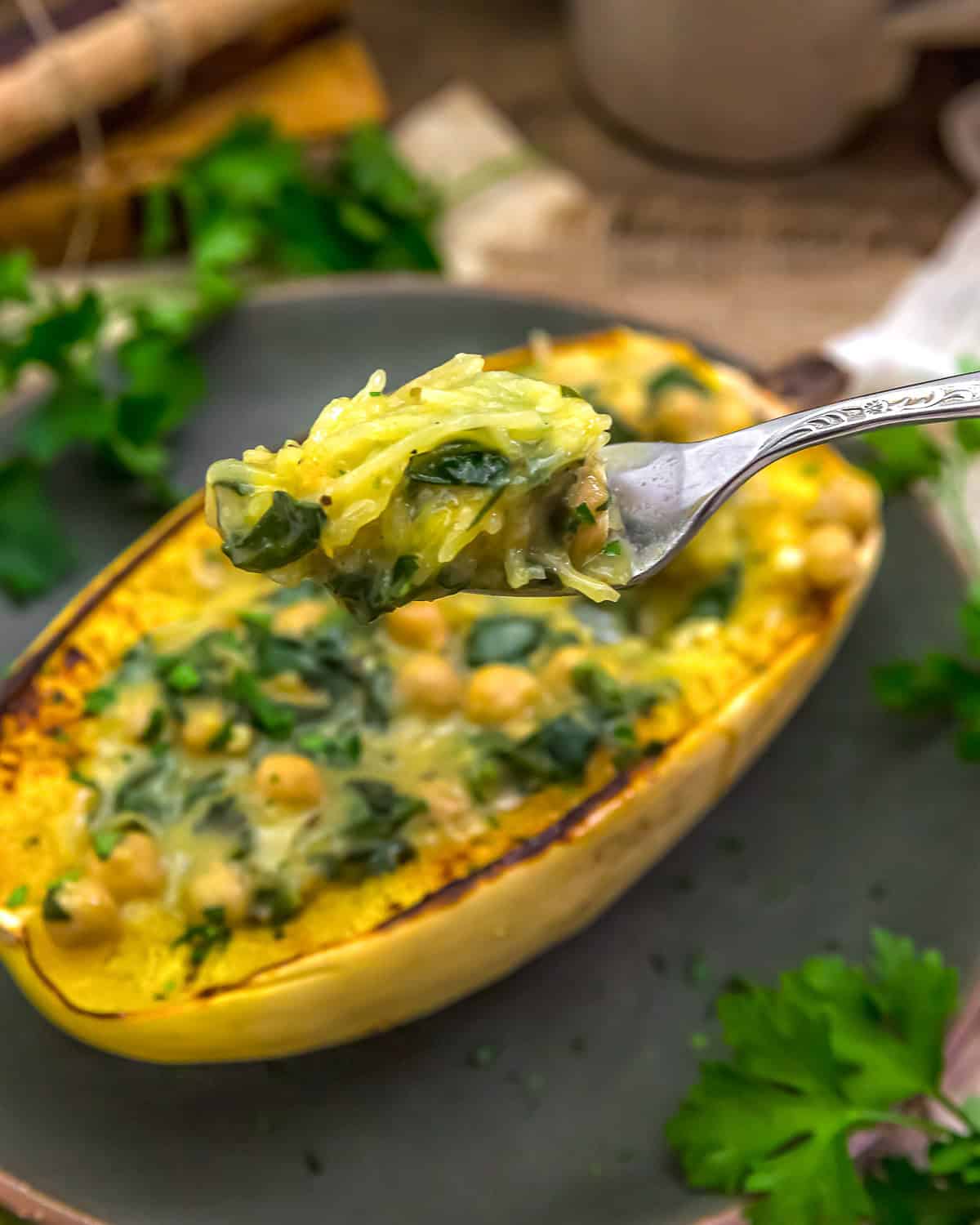 Low-Fat Stuffed Spaghetti Squash with Creamy Garlic Chickpea Spinach Sauce with text description