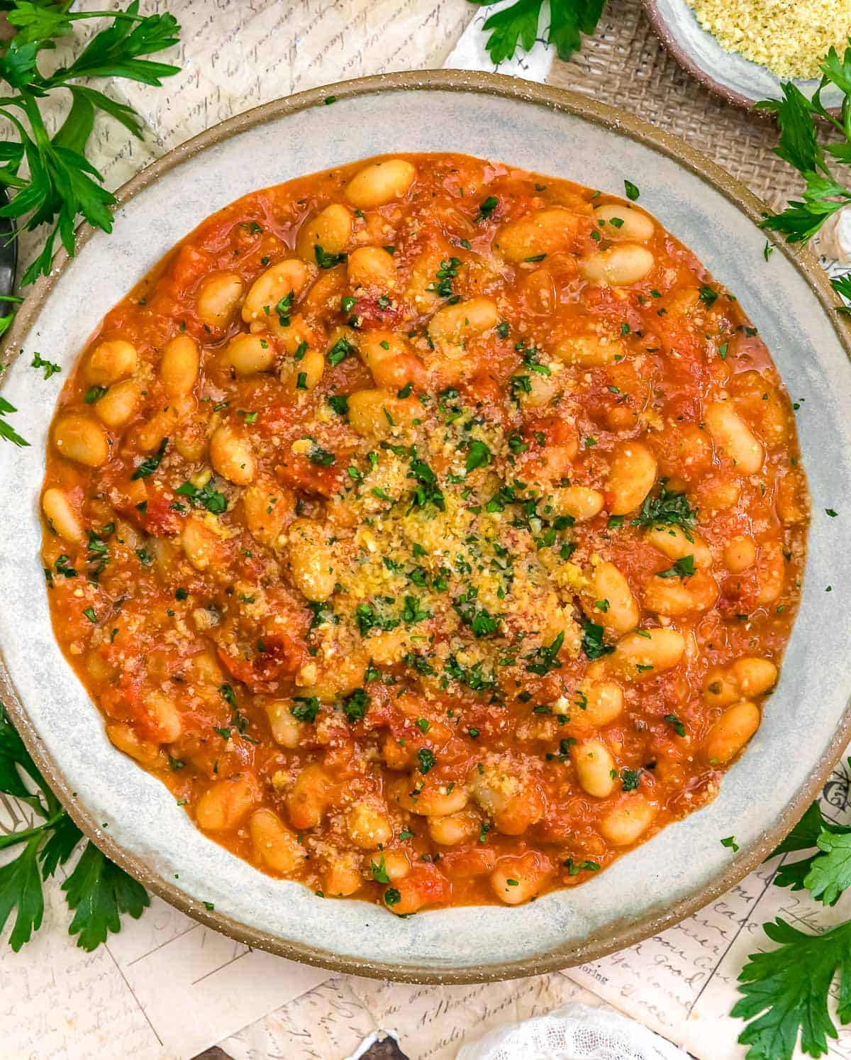 Bowl of Easy Vegan Parmesan White Beans in Red Sauce