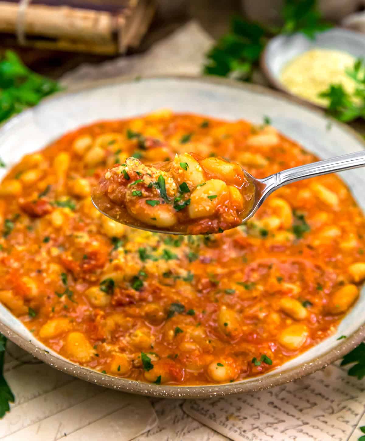 Spoonful of Easy Vegan Parmesan White Beans in Red Sauce