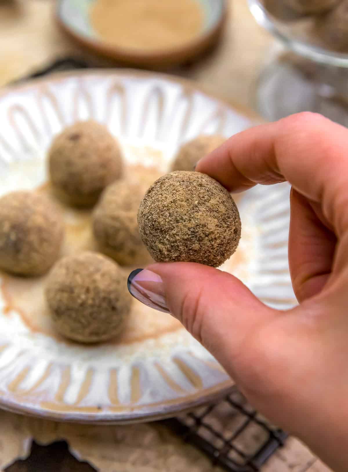 Holding a Healthy Churro Date Bliss Ball