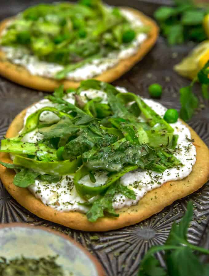 Vegan Asparagus Ricotta Flatbread Pizza on a baking sheet
