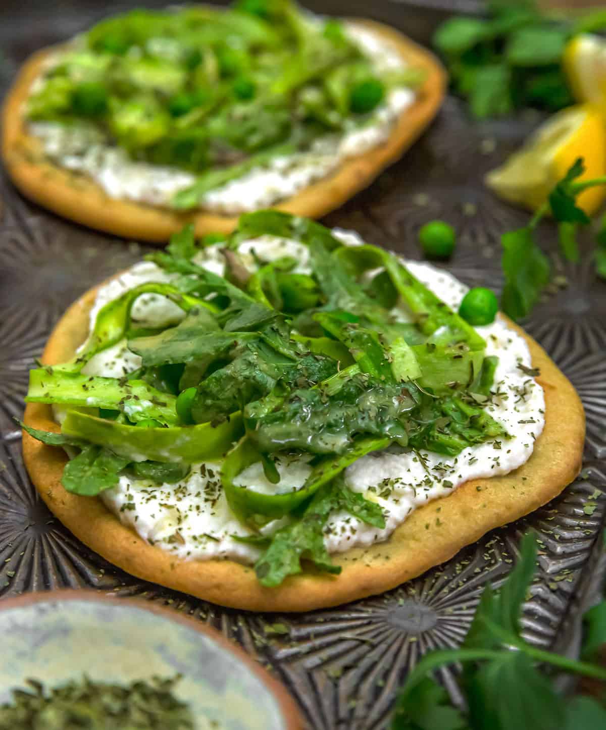 Vegan Asparagus Ricotta Flatbread Pizza on a baking sheet