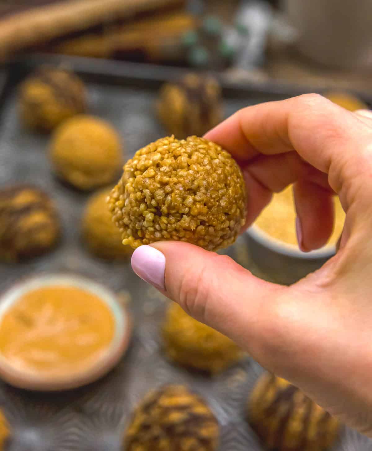 Holding a No-Bake Puffed Quinoa Peanut Butter Cookie