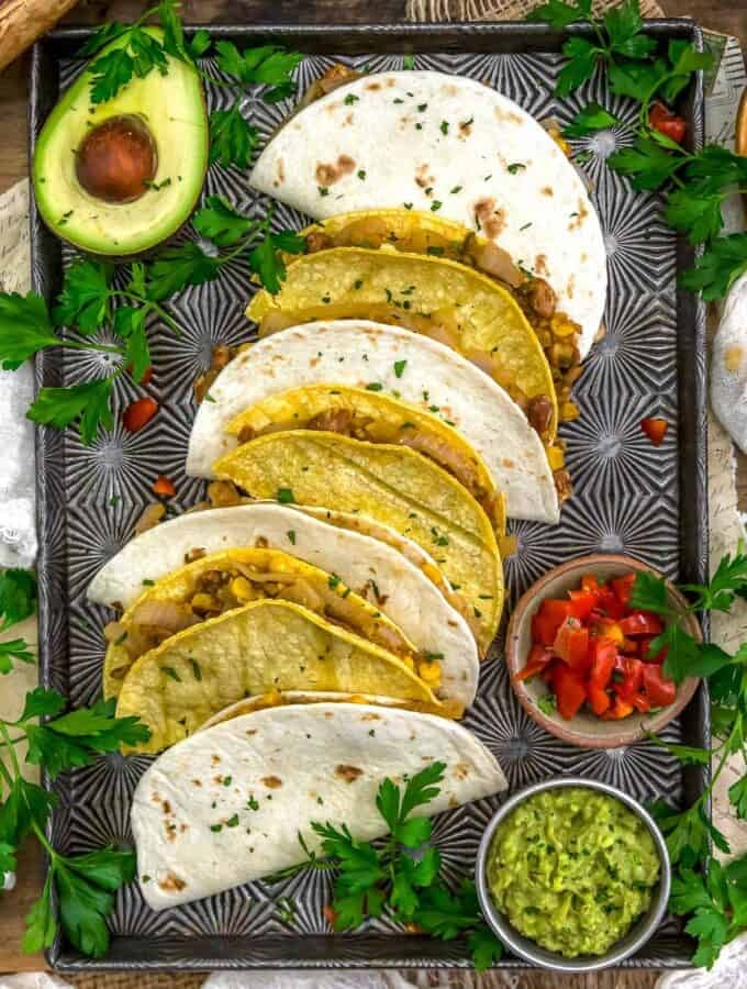 Baking sheet of Smashed Pinto Bean and Grilled Onion Tacos