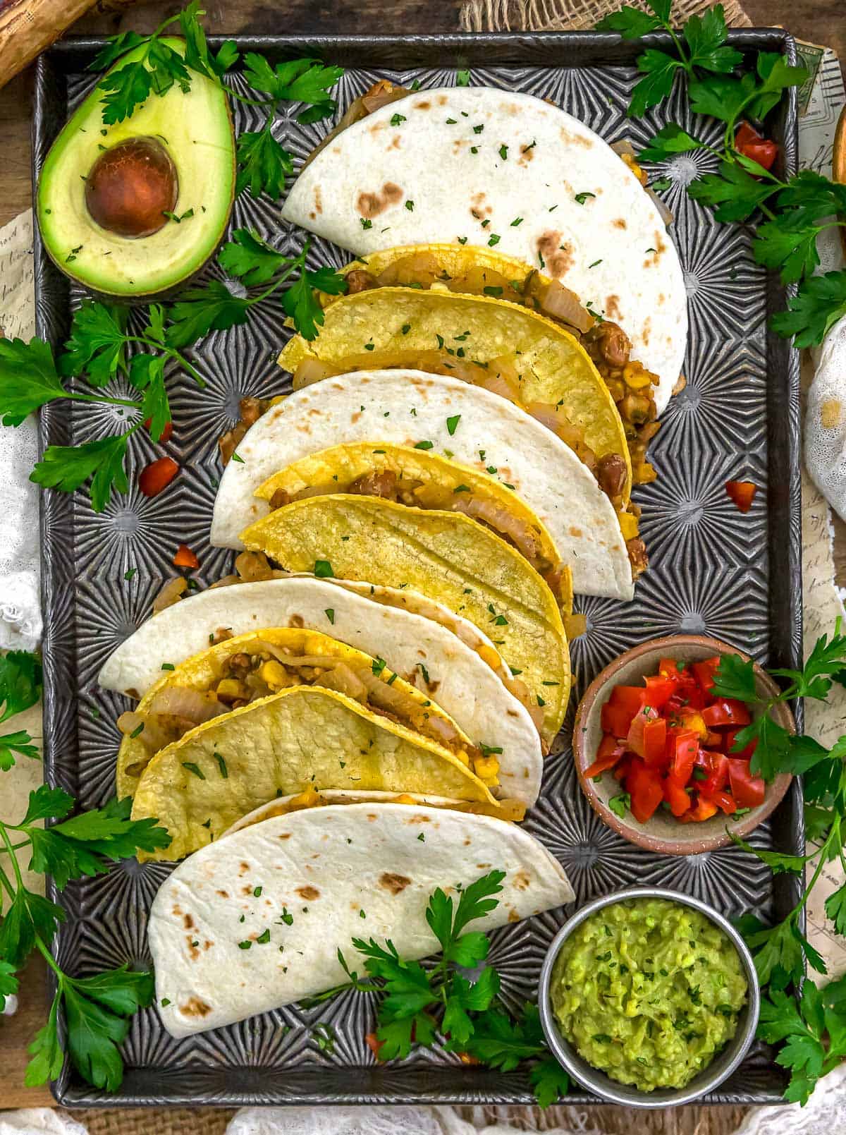 Baking sheet of Smashed Pinto Bean and Grilled Onion Tacos