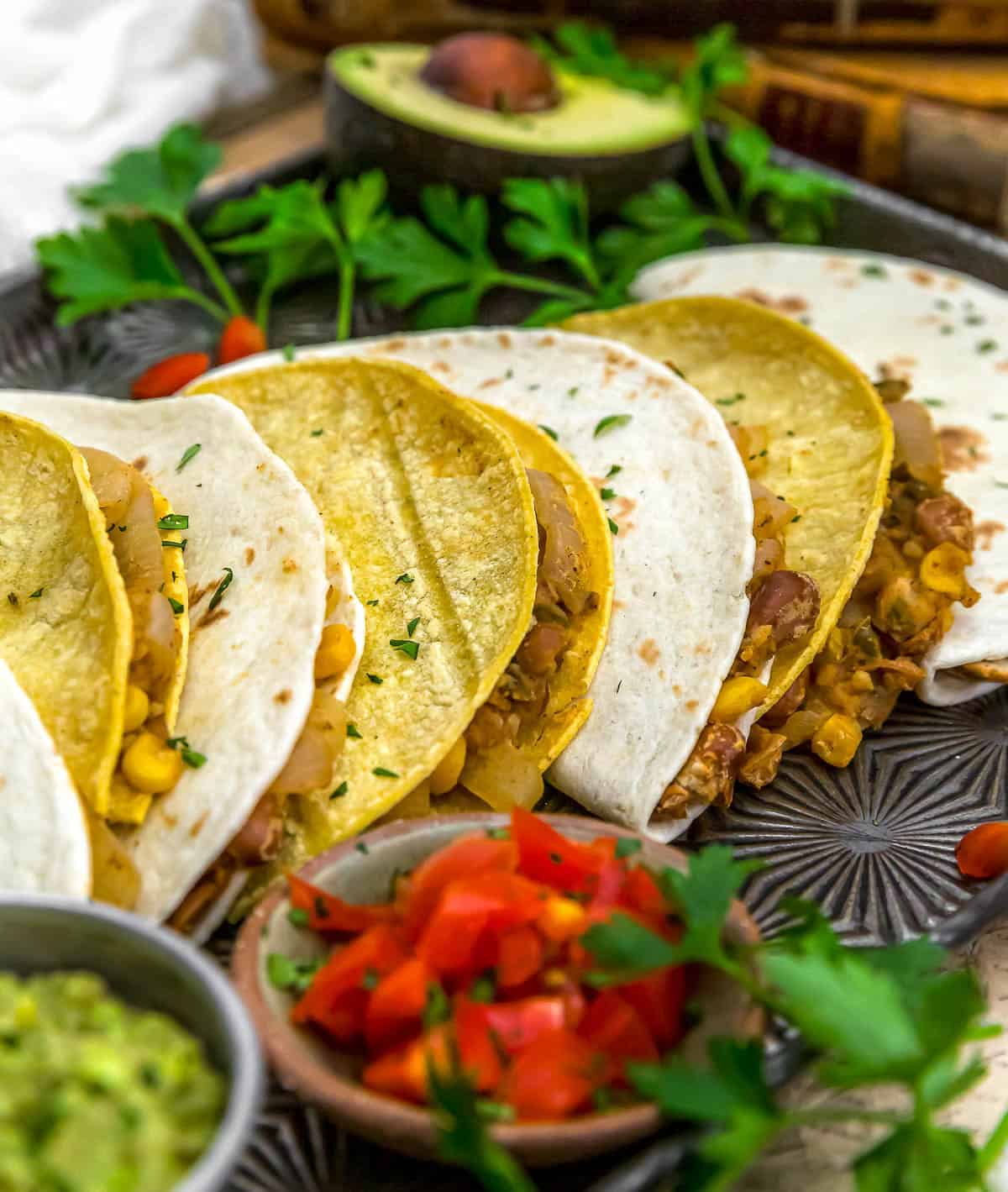 Side view of Smashed Pinto Bean and Grilled Onion Tacos