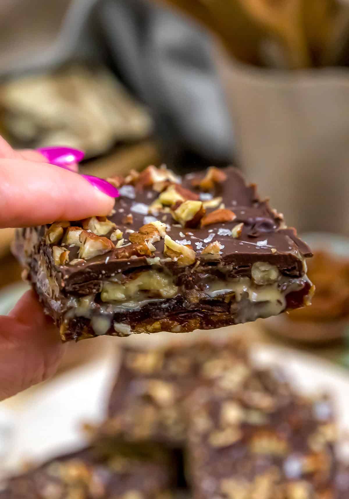 Holding a Chocolate Pecan Date Tahini Bar