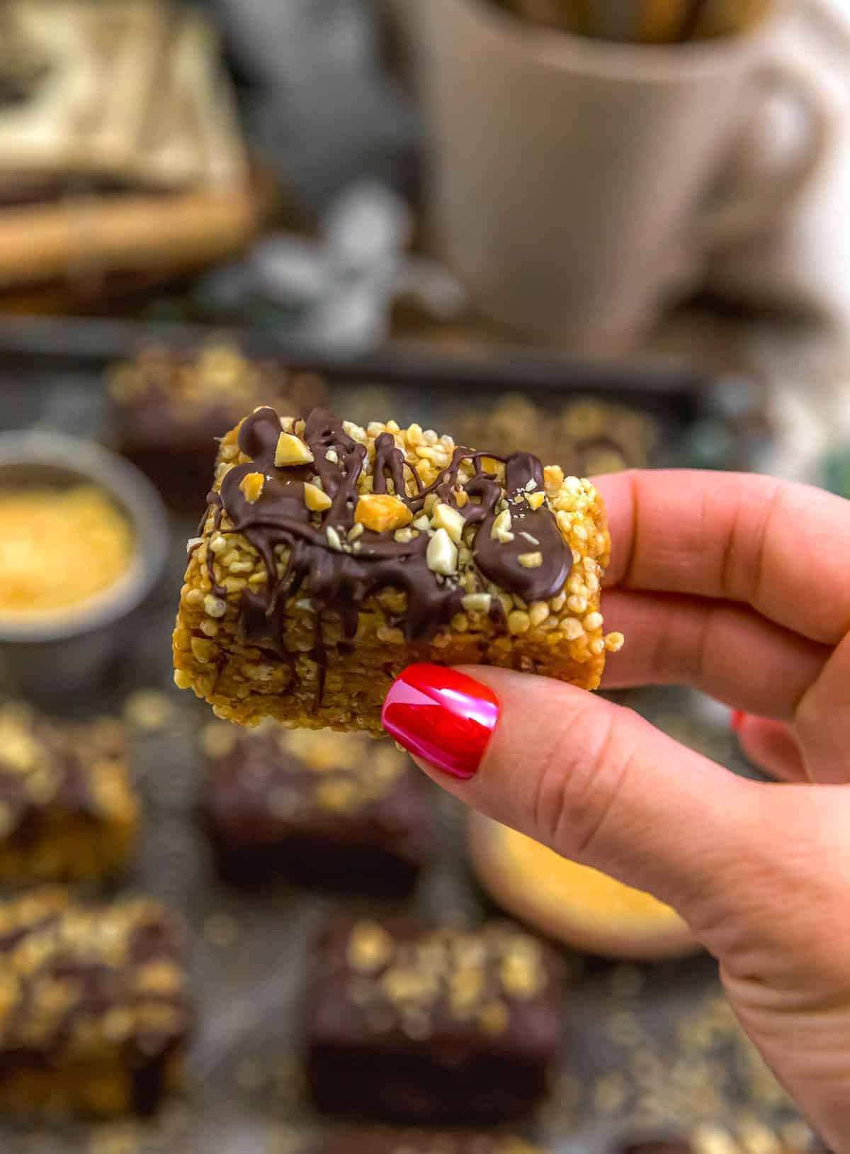 Holding a Peanut Butter Chocolate Puffed Quinoa Crunch Bar